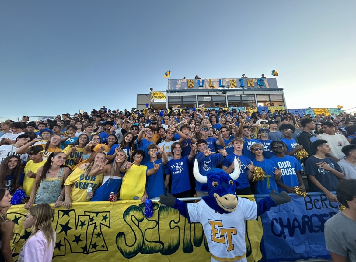 The Bullring student section, wearing yellow and blue, poses for a photo pre-game.