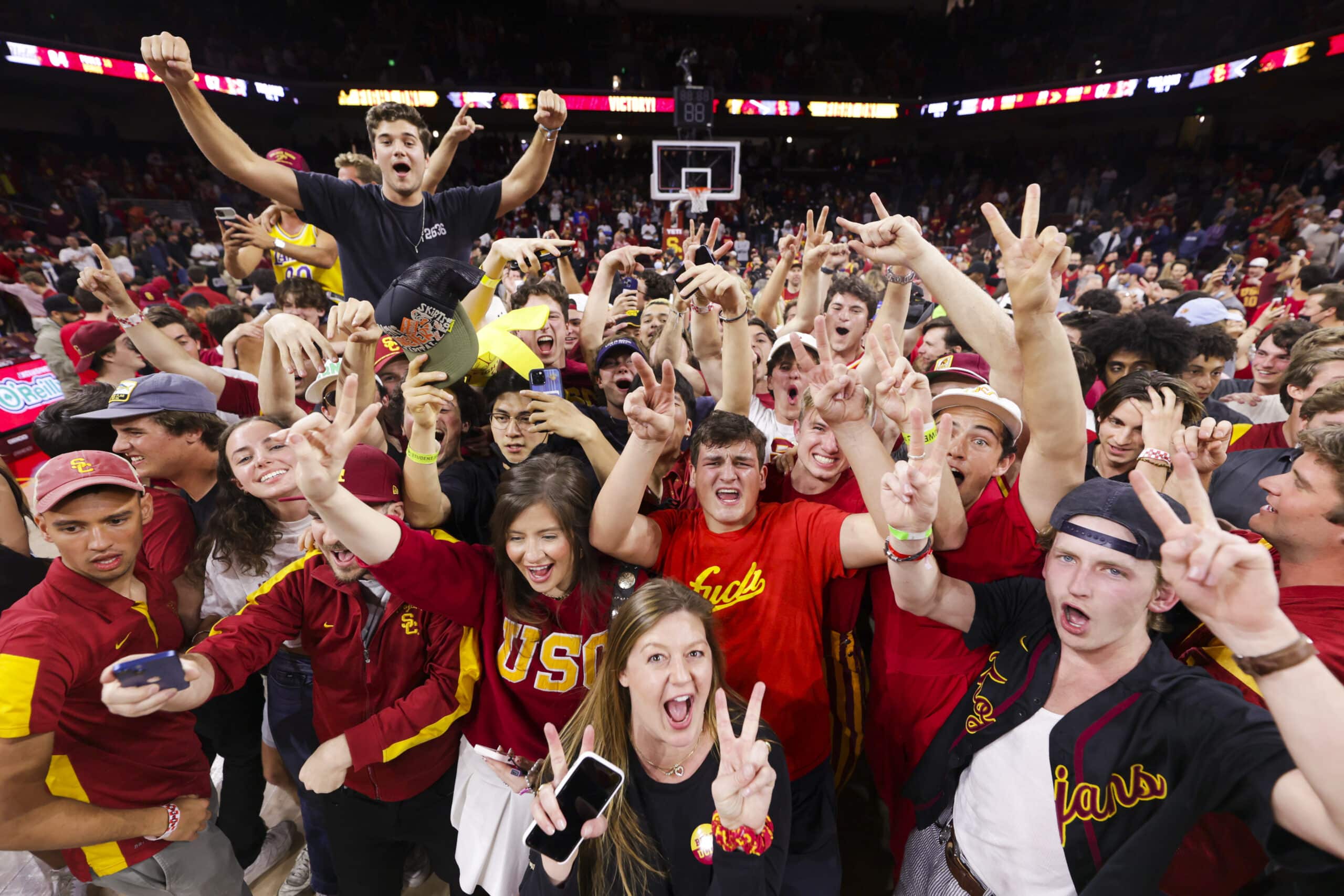 USC student section, the Legion, passionately cheering in support of their men's basketball team, creating an electrifying atmosphere at the game.