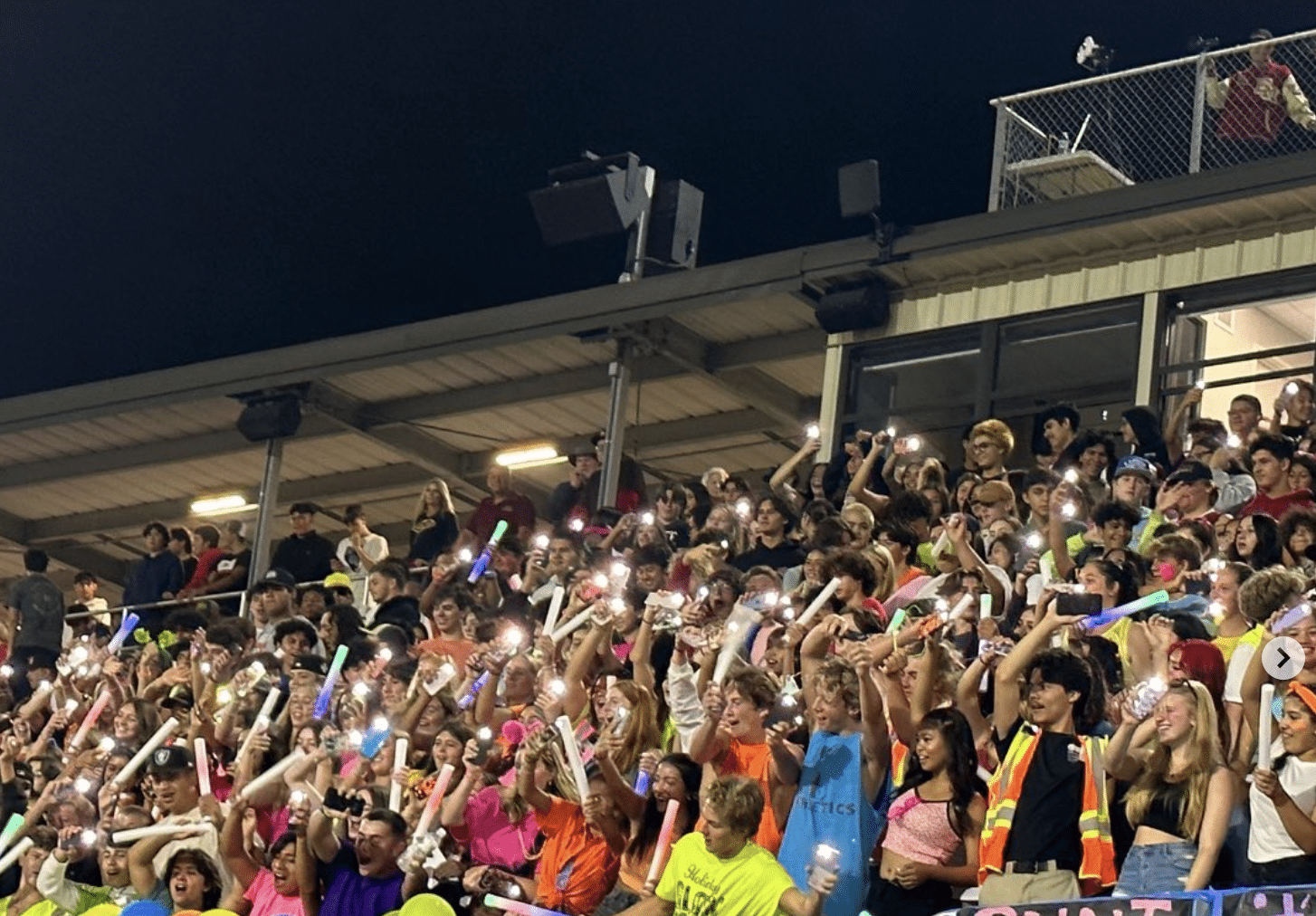 El Modena High School student section immersed in the excitement of Neon Night