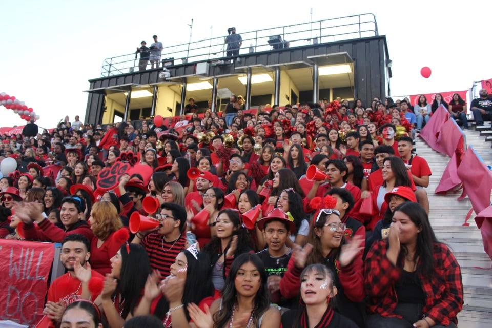 Segerstrom High School students cheering with excitement in the stands, showing their spirited support for their school's team.