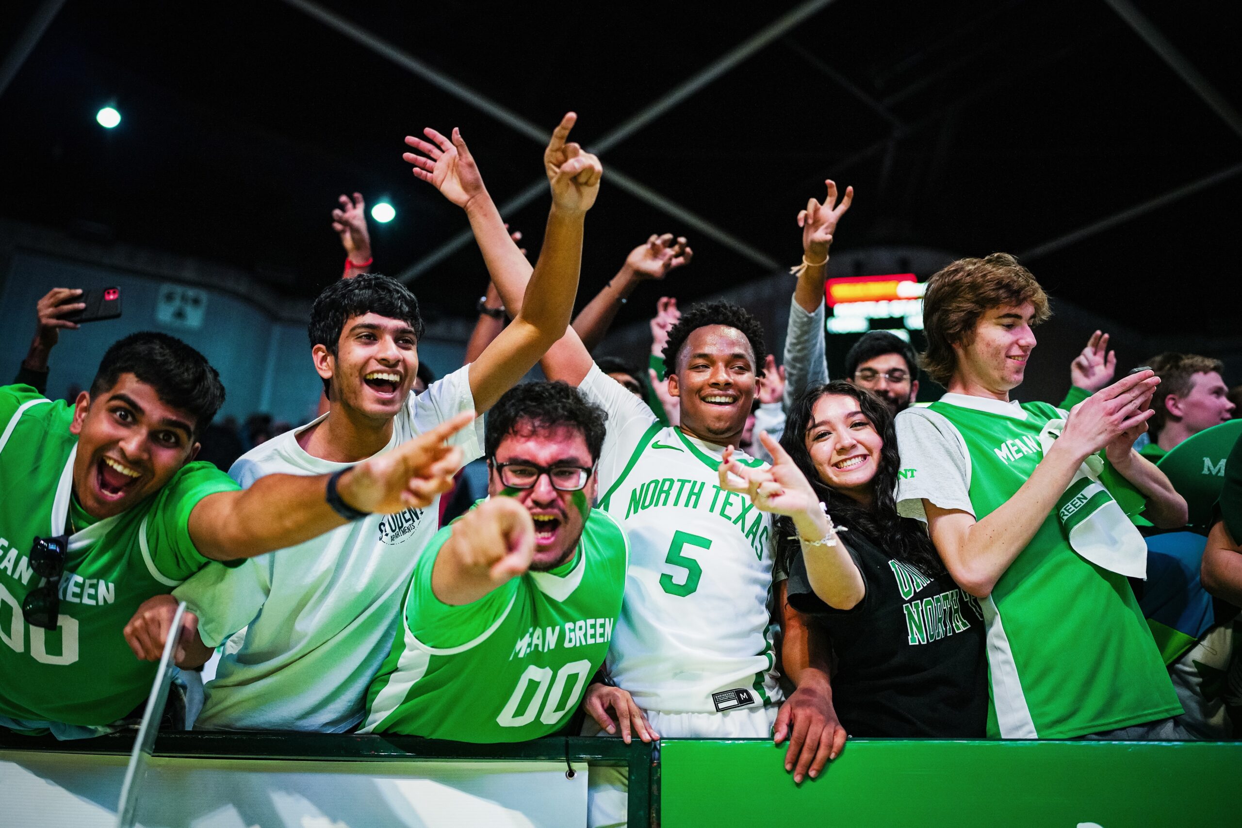 UNT Mean Green Maniacs student section celebrating after a win.